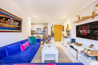 a living room with a blue couch and a table at AkHouse PB15 Fully Equipped - Guéliz TOP Center in Marrakech