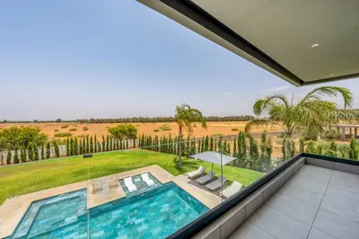 a view from the balcony of a house with a swimming pool at Villa Arbia - Piscine - 5BDR - Fitness - Ping-Pong in Sraghna