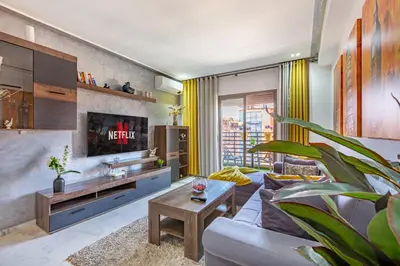 a living room with a couch and a tv at Luxury CINÉMA-BEDROOM AK38 FullHD Guéliz-TopCenter in Marrakech