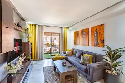 a living room with a couch and a table at Luxury CINÉMA-BEDROOM AK38 FullHD Guéliz-TopCenter in Marrakech
