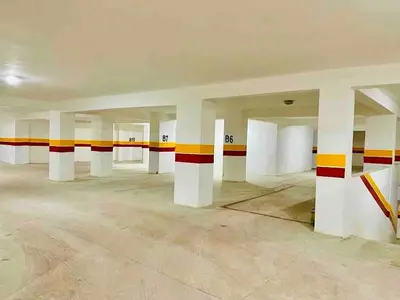 an empty room with white columns and red and yellow stripes at Luxury CINÉMA-BEDROOM AK38 FullHD Guéliz-TopCenter in Marrakech