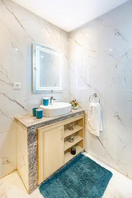 a bathroom with a sink and a mirror at Luxury CINÉMA-BEDROOM AK38 FullHD Guéliz-TopCenter in Marrakech