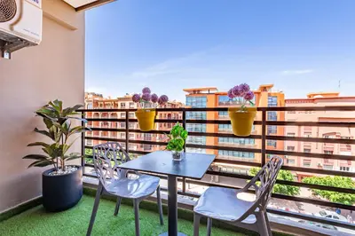 a table and chairs on a balcony with a view at Luxury CINÉMA-BEDROOM AK38 FullHD Guéliz-TopCenter in Marrakech