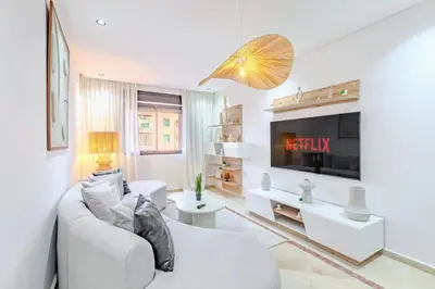 a living room with a couch and a tv at Modern Apartment Gueliz City Center in Marrakech