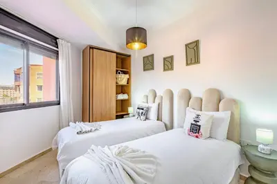a bedroom with two beds and a window at Modern Apartment Gueliz City Center in Marrakech