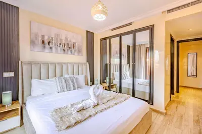 a bedroom with a bed with a towel on it at Stylish Apartment with Terrace Central Marrakech in Marrakech