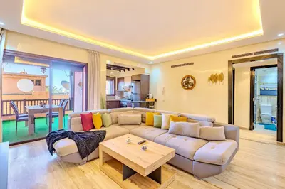 a living room with a couch and a table at Stylish Apartment with Terrace Central Marrakech in Marrakech
