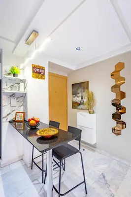 a dining room with a table and chairs at Luxury CINÉMA-BEDROOM AK04 Guéliz-TopCenter in Marrakech
