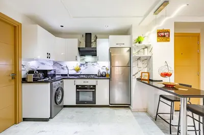 a kitchen with stainless steel appliances and a table at Luxury CINÉMA-BEDROOM AK04 Guéliz-TopCenter in Marrakech