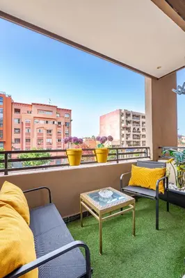 a balcony with two chairs and a coffee table at Luxury CINÉMA-BEDROOM AK04 Guéliz-TopCenter in Marrakech