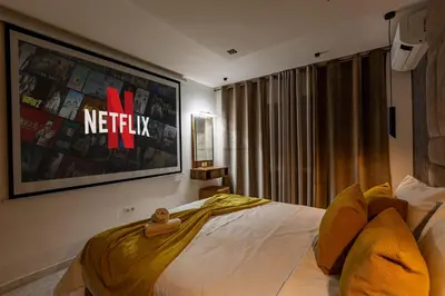 a bedroom with a bed with a television on the wall at Luxury CINÉMA-BEDROOM AK04 Guéliz-TopCenter in Marrakech