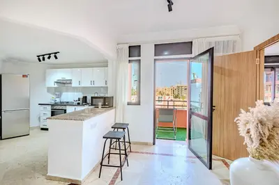 a kitchen with a counter and stools at Manahil Modern Apartment Gueliz City Center in Marrakech