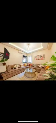 a living room with a couch and a coffee table at Évasion urbain de luxe climatisation fibre in Marrakech
