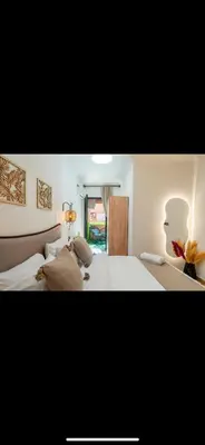 a bedroom with a large bed and a window at Évasion urbain de luxe climatisation fibre in Marrakech
