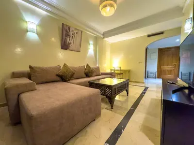 a living room with a couch and a coffee table at Majorelle Apartment - Terrace Stunning Garden View in Marrakech