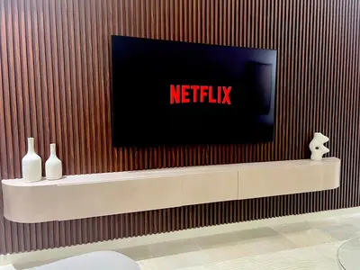 a tv screen on a wall with vases on a shelf at Résidence Ménara Garden Proche Gare & Jardins Ménara in Marrakech