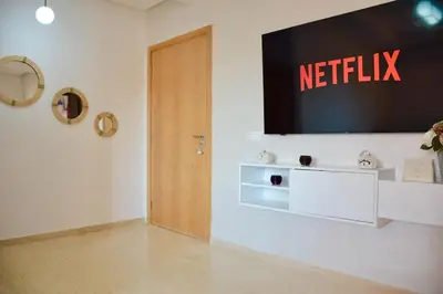 a waiting room with anetflix sign on the wall at Appartement calme et ensoleillé avec piscine in Marrakech