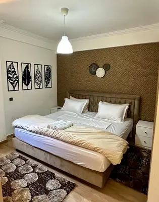 a bedroom with a large bed in a room at Moderne appartement centre Marrakech in Marrakech