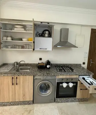 a kitchen with a sink and a washing machine at Moderne appartement centre Marrakech in Marrakech