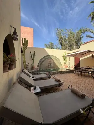 a patio with a bunch of tables and chairs at Luxury Private Riad, Air-Conditioned and Pool in Marrakech
