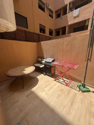 a room with a table and a piano in a building at Studio au centre ville in Marrakech