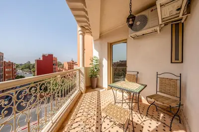 a balcony with two chairs and a table at Pearl of Guéliz Netflix, Terrace, Quiet in Marrakech