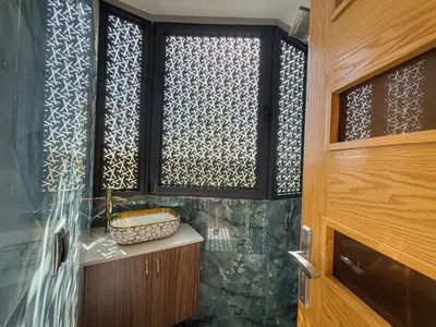 a bathroom with a window with a basket on a counter at Essalmi Luxury Apartment in Marrakech in Marrakech