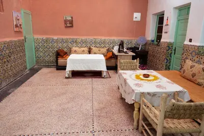a living room with a table and a couch at Riad Nomad in Marrakech