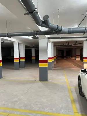 a parking garage with colorful columns and a car parked in it at Pool View Quiet et Comfort in Marrakech