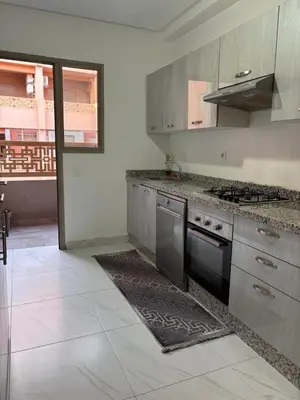 a kitchen with stainless steel appliances and a stove at La citrine in Marrakech