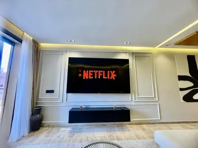 a living room with a netflix tv on a wall at The Gueliz Escape - 2BR Luxury Flat in Marrakech