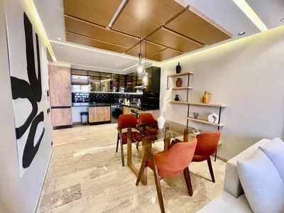 a dining room and living room with a table and chairs at The Gueliz Escape - 2BR Luxury Flat in Marrakech