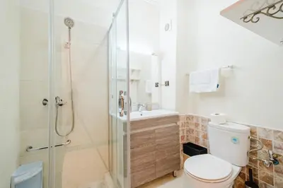 a bathroom with a shower and a toilet and a sink at Central Marrakech Apartment 2 Bedrooms Next to Majorelle Garden in Marrakech