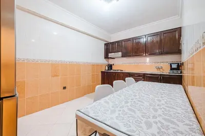 a kitchen with a table and chairs in a room at Central Marrakech Apartment 2 Bedrooms Next to Majorelle Garden in Marrakech