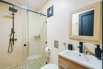 a bathroom with a sink and a shower and a toilet at Charmant appartement lumineux pres de Gueliz. in Marrakech