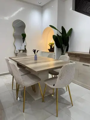 a dining room with a wooden table and chairs at Duplex Menara Mall in Marrakech