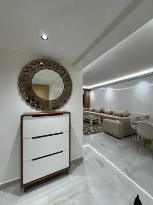 a living room with a dresser and a mirror at Duplex Menara Mall in Marrakech