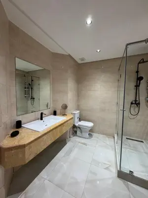 a bathroom with a sink and a shower and a toilet at Duplex Menara Mall in Marrakech