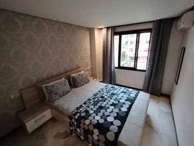 a small bedroom with a bed and a window at Studio Centre Ville in Marrakech