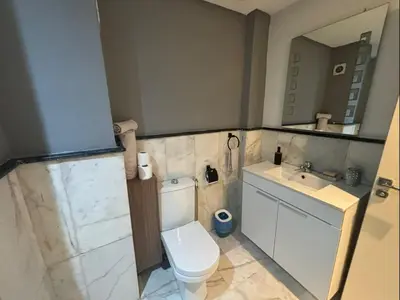 a small bathroom with a toilet and a sink at Studio Centre Ville in Marrakech