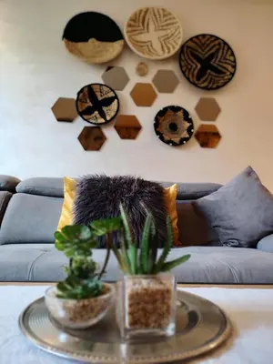 a living room with a couch and a table with plants at Studio Centre Ville in Marrakech