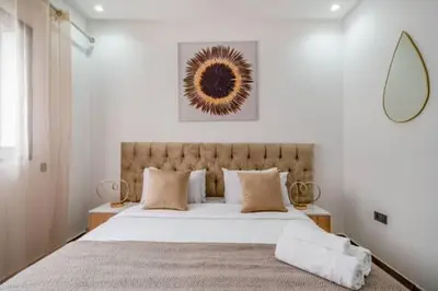 a bedroom with a large bed with white sheets and pillows at Emplacement idéal fraîcheur garantie, piscine netflix in Marrakech