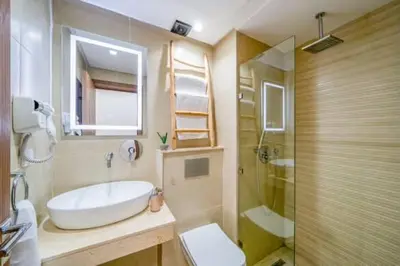 a bathroom with a tub and a sink and a toilet at Emplacement idéal fraîcheur garantie, piscine netflix in Marrakech
