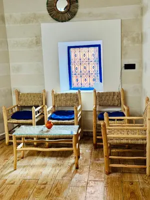 a room with four chairs and a table and a window at Maison N 07 in Marrakech