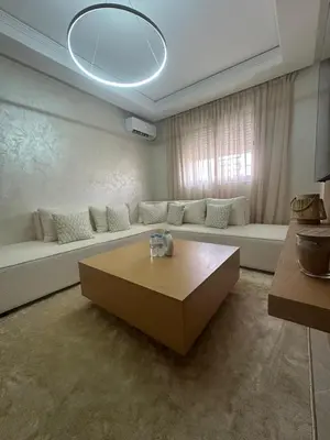 a living room with a couch and a coffee table at Appartement 2 chambre cosy in Marrakech