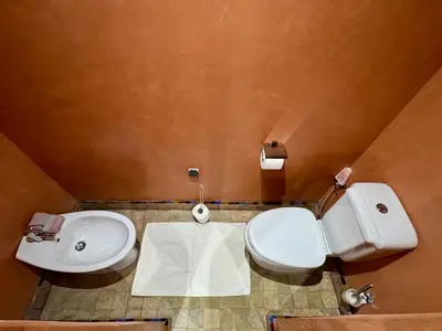 a bathroom with a white toilet and a sink at Oasis de Charme au coeur de la zone touristique in Marrakech