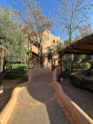 a driveway with a car parked in front of a house at Oasis de Charme au coeur de la zone touristique in Marrakech