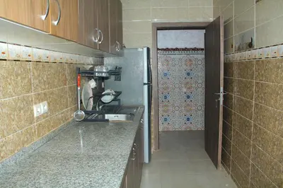 a small kitchen with a sink and a refrigerator at apartment,5 min to airport, In a quiet place in Marrakech