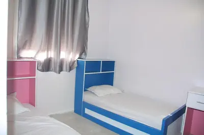 a small bedroom with a blue bunk bed at apartment,5 min to airport, In a quiet place in Marrakech