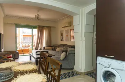 a living room with a couch and a table at Appartement 2 bedroom Babylone center in Marrakech